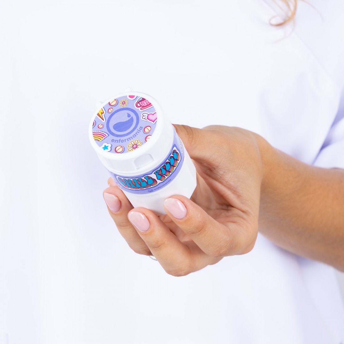 White and lilac medical tool container held by a healthcare worker, useful for storing small equipment or medications, with a secure lid and compact design.